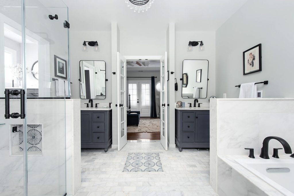 A crisp white bathroom with high-contrast modern designs